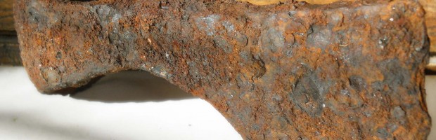 cleaning a rusted axe head