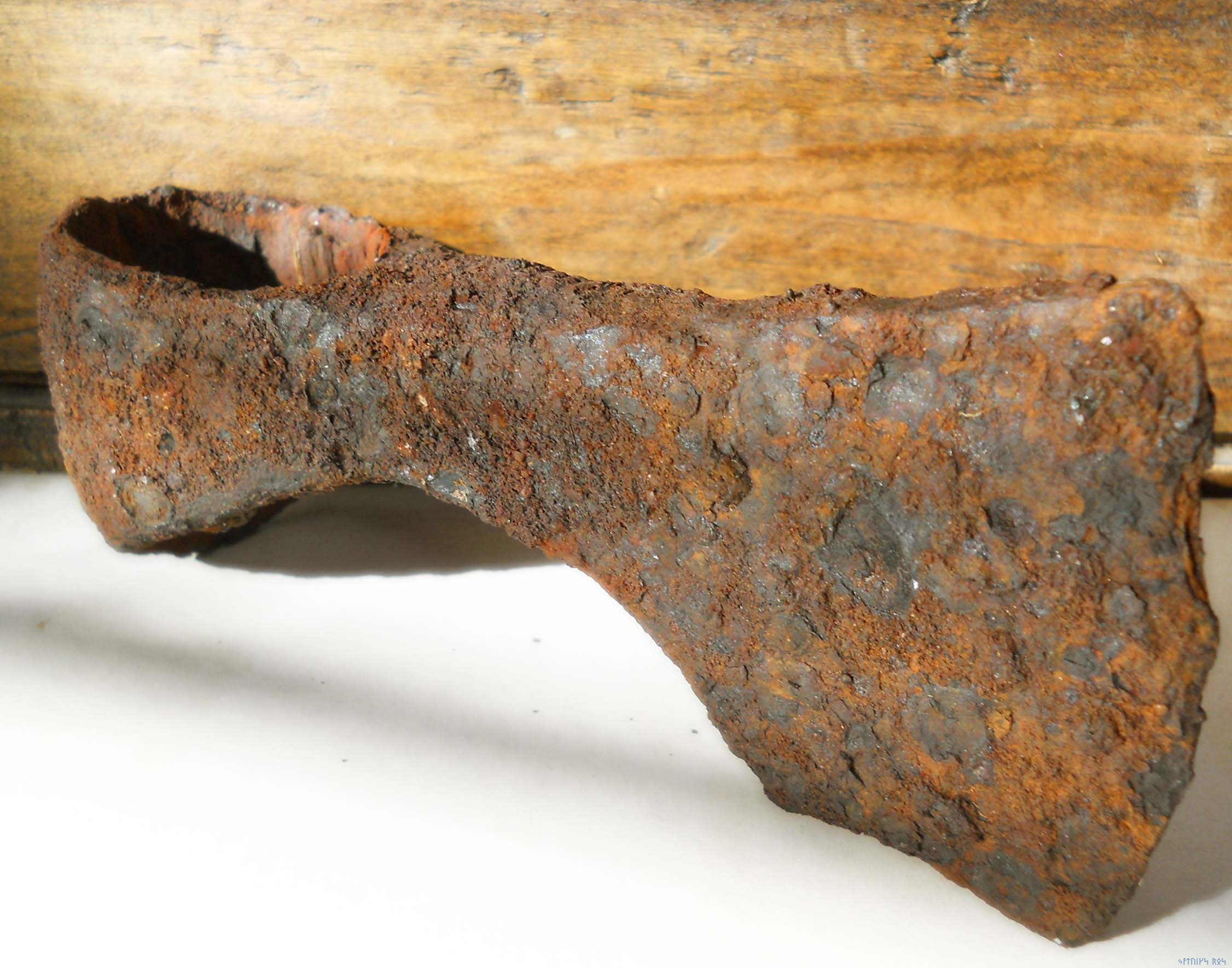 cleaning a rusted axe head 